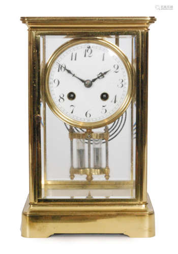 A 20th Century brass bevelled cased mantle clock with circular white enamelled dial and mercury suspended pendulum