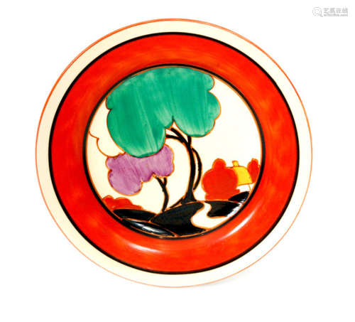 A Clarice Cliff Green Autumn circular side plate circa 1930 hand painted with a stylised tree and cottage landscape with black and red banding