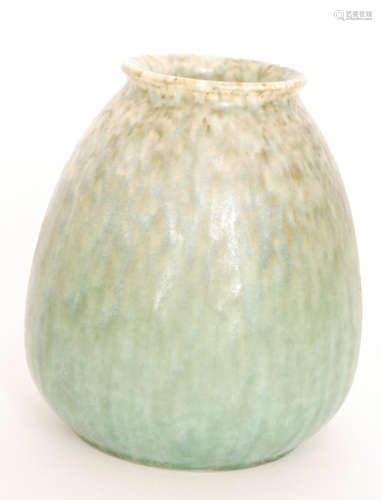 A Ruskin Pottery crystalline glaze vase decorated in a mottled and streaked green over a mustard ground