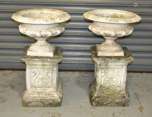 A pair of 19th Century small cast iron terrace urns of waisted acanthus form