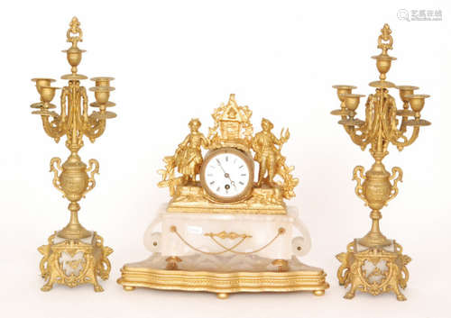 A 19th Century gilt metal clock garniture mounted with two figures and a pair of candelabras on white alabaster bases