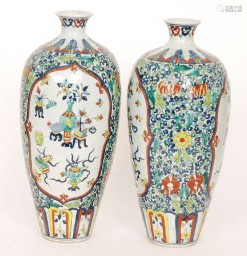 A pair of Chinese vases of high shouldered form with a squat flared neck