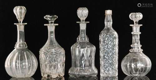 A group of 19th Century and later clear glass decanters comprising a pillar moulded bell form example