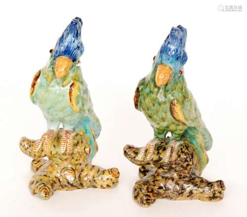 Two continental model parrots each glazed in green with blue feathered plumes