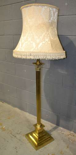 A 20th Century brass standard lamp with Corinthian column over a stepped base