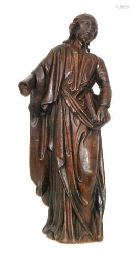 A late 18th Century carved oak figure of a standing robed apostle holding a book in his left hand