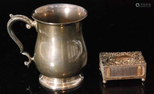 A hallmarked silver tankard of plain baluster form