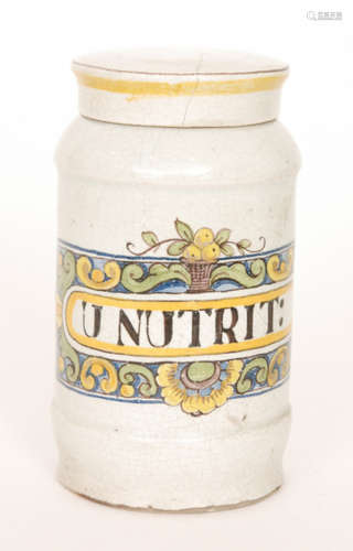 An early 20th Century tin glazed maiolica type drug jar decorated to the front with a rectangular cartouche with flowers and fruit framing U NUTRIT: