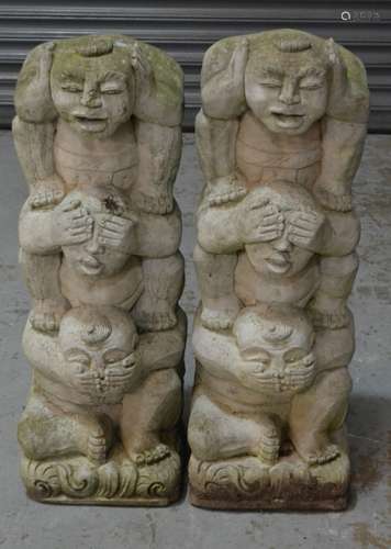 A pair of contemporary figural garden concrete statues; hear no evil