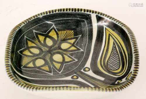 A post war Danish studio pottery bowl of rounded square form decorated with a hand painted stylised flower in black and yellow