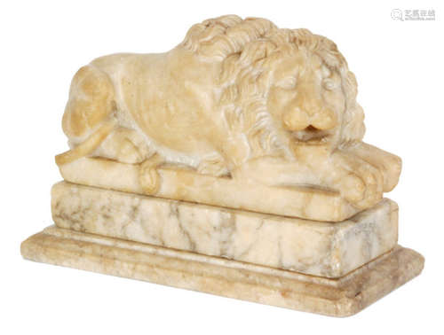 A 19th Century carved alabaster recumbent lion with flowing mane