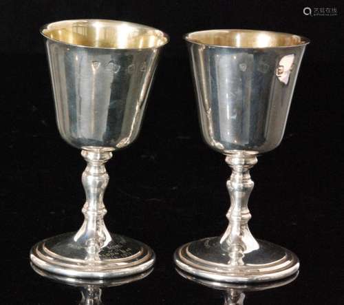 A pair of hallmarked silver goblets each with gilt washed bowl above knopped stem and circular foot