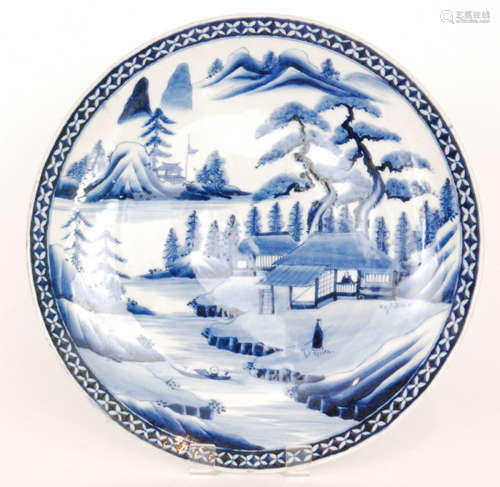 A large late 19th to early 20th Century Japanese export charger decorated in blue and white with pagodas and trees by the river bank with Mount Fuji in the distance