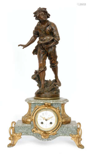 A late 19th to early 20th French spelter gilt mantle clock modelled with a figure of a boy holding his hat with a nest of chicks above a green veined marble base and scroll feet