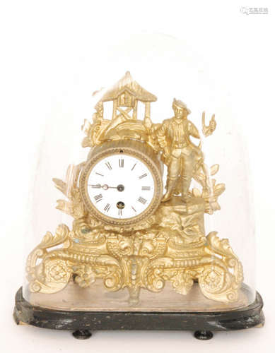 A small 19th French pressed gilt metal mantle clock and dome