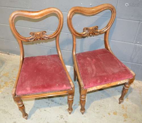 A set of four Victorian carved mahogany drawing room chairs with pierced backs overstuffed crimson seats