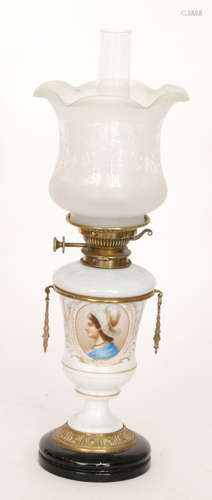 A Victorian brass oil lamp and shade with transfer panel of a girl wearing a headress on gilt and white opaque urn base