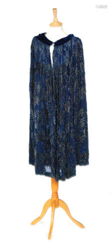 A 1920s ladies vintage cape in blue chiffon with a matching blue velvet rim and collar