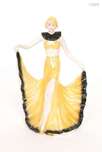 A 1930s Art Deco model of a dancing girl dressed in a yellow croplet