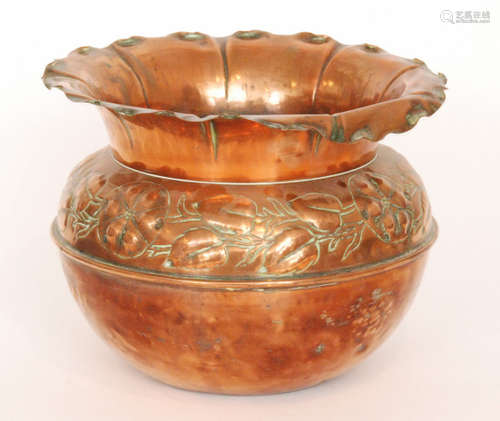 A late 19th to early 20th Century copper jardiniere or planter of bulbous circular outline embossed with passion fruit flowers amidst trailing leaves and stems below a flared and crimped rim