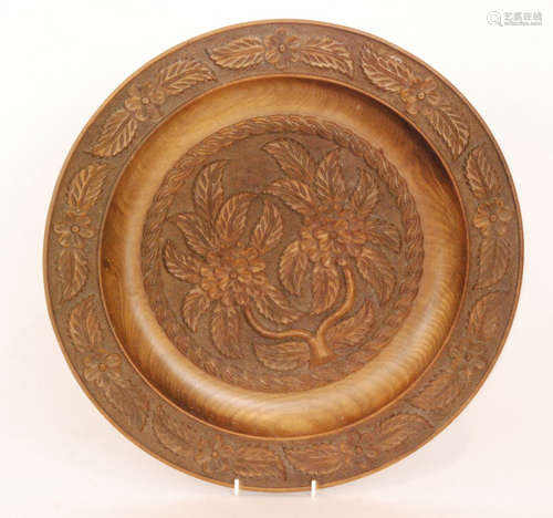 A 19th Century Black Forest carved walnut dish with raised border