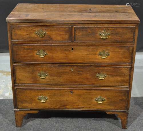 A George III oak straight front chest of two short over three long drawers