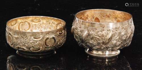 Two hallmarked silver small circular bowls each with embossed foliate decoration to whole