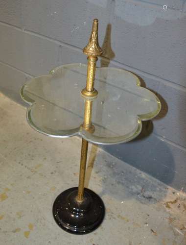 A Victorian mirrored display stand with central brass column on black glass base