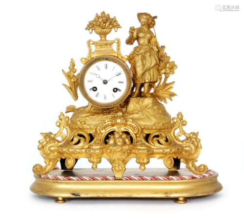 A 19th Century French pressed gilt metal mantle clock mounted with a farm girl holding a rake above a circular dial on scroll base in glass dome