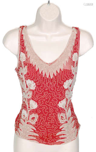 A 1920s ladies vintage beaded bodice top in a red pink chiffon with a white and clear beadwork floral design to the front and back