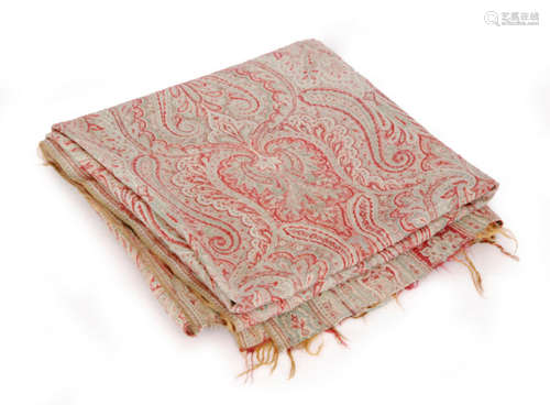 An early 20th Century Paisley shawl mainly in a pale red and green with repeat stylised patterns