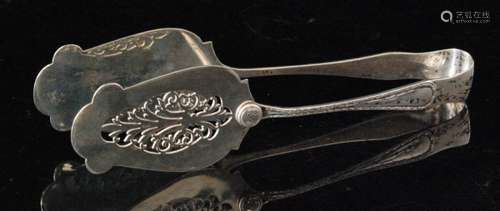 A set of hallmarked silver asparagus servers of pierced foliate design with shaped outline and bead and reel handles