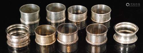 Two pairs of hallmarked silver circular napkin rings with five further silver examples