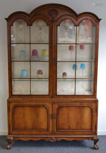 A walnut dome topped display cabinet in the Queen Anne style