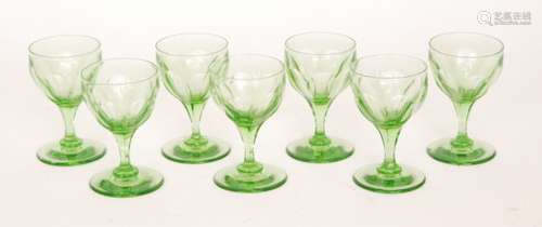 A set of seven 19th Century uranium green wine glasses