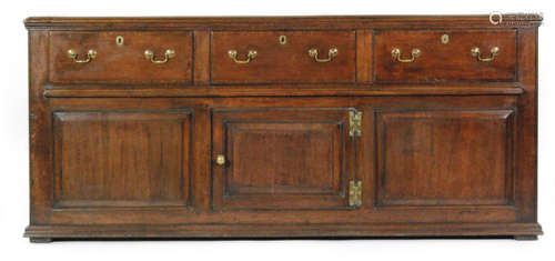 A George III oak and mahogany crossbanded three drawer dresser