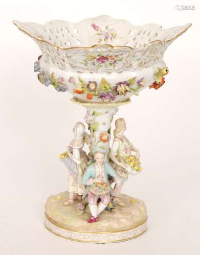 An early 20th Century floral encrusted pedestal fruit basket with figures stood around the central pedestal offering lemons and flowers