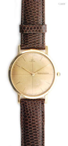 A 1950s 18ct hallmarked gentleman's Jaeger Le Coultre manual wind wrist watch with batons to a champagne circular dial