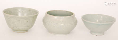 Three studio pottery footed bowls each in a celadon glaze with incised decoration