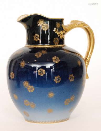 An early 20th Century Haviland & Co Limoges jug decorated in a tonal blue with a gilt applied flower head design