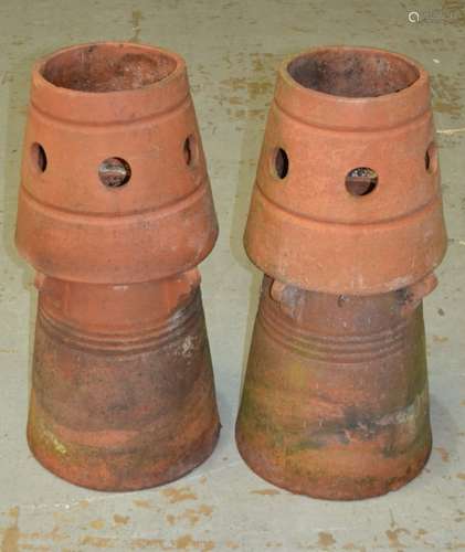 A pair of terracotta conical shaped chimney pots