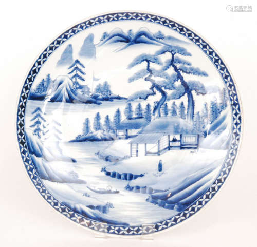 A large late 19th to early 20th Century Japanese export charger decorated in blue and white with pagodas and trees by the river bank with Mount Fuji in the distance