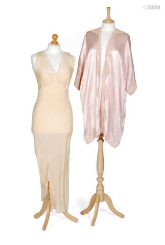 A 1930s ladies vintage pink satin bed robe with a pale pink lace trim