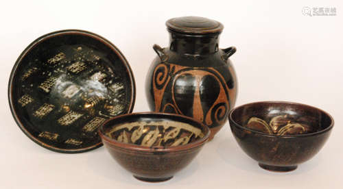 A studio pottery lidded vessel decorated in an all over black glaze with wax resist decoration to the body