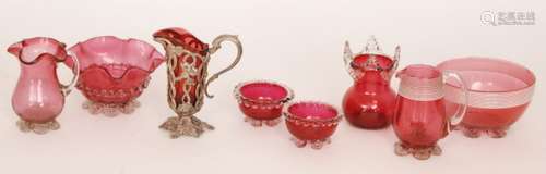 A group of late 19th Century Cranberry glass comprising a cream jug in white metal mounts with floral decoration