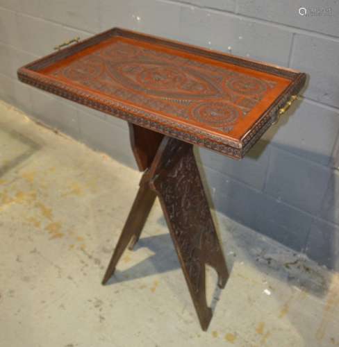 A late 19th Century carved mahogany rectangular two handled serving tray together with an associated folding stand