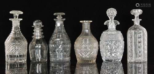 A group of six 19th Century and later clear glass decanters comprising an example with a diamond cut band below a mitre cut neck