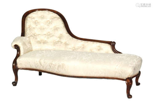 A Victorian carved mahogany framed chaise longue of serpentine outline