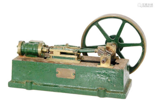 A green painted cast iron model of a steam engine