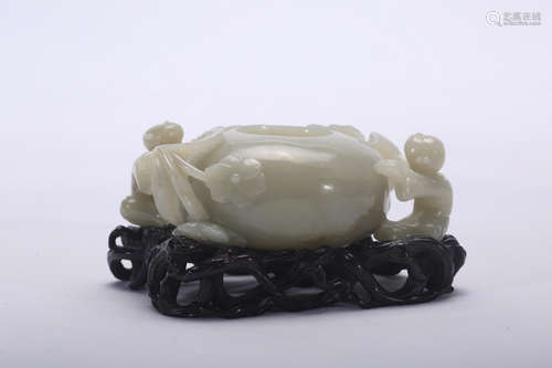 Chinese carved jade water coupe on wood stand.